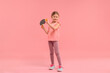 © New Africa - Cute little girl with ping pong racket and ball on pink background