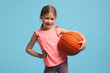 © New Africa - Cute little girl with basketball ball on light blue background