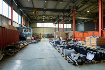 Aufkleber - Group of wooden pallets with stacks of wrapped spare parts produced at modern factory equipped for making industrial items