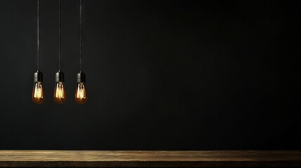 Canvas Print -   Three light bulbs on black wall with wooden table in front