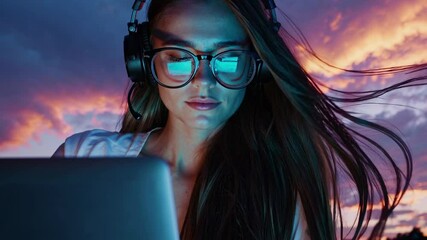 Skilled software engineer working with concentration on laptop, capturing innovative technology moment during windswept sunset environment, hair flowing with digital professional energy