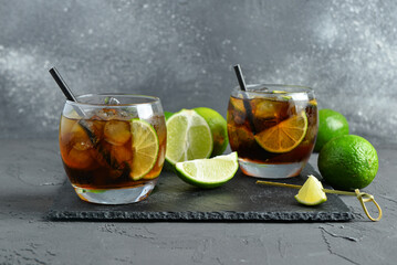 Poster - Glasses of cold Cuba Libre cocktail on grey background