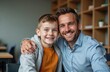 © miss irine - Young boy, tutor smiling at camera indoors. Happy child hugs man, friendship, integration. Teacher helping kid with developmental delays at school classroom, care, positive support. Inclusive