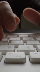 Wall Mural - close-up man typing on computer keyboard with hands and fingers. macro soft focus dolly shot. comput
