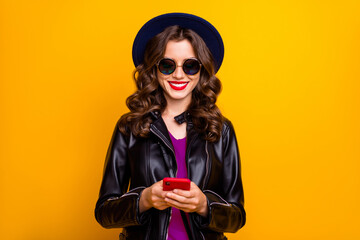 Wall Mural - portrait of charming cheerful positive girl use her cellphone comment text blog post wear black leat