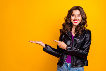 Wall Mural - Photo of pretty lady promoter holding on arm best product for final low price wear leather jacket isolated yellow color background