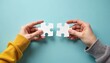 © miss irine - Two hands putting together puzzle pieces cooperation, unity. Solving jigsaw puzzle as concept of partnership, connection. Teamwork, collaboration in business strategy metaphor, find solution.