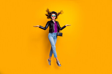 Wall Mural - full size photo of excited girl show ads enjoy walk jump wear black leather jacket denim jeans isola