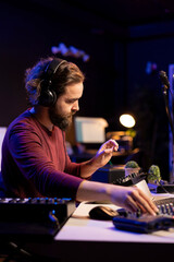 Leinwandbilder - Audio engineer using stereo console to add sound effects on songs, working with daw software on pc for post production. Composer songwriter producing new tracks with amplifier and recordings.