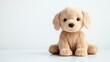 © SlashStd - Fluffy toy puppy sits on white background;  cute pet for kids' room decor