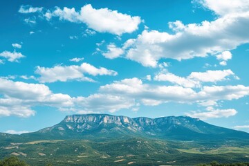 Fototapete - Majestic mountain range beneath soft clouds in blue sky with space for your creative message. Generative AI