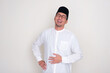 © KrishnaTedjo - Muslim man touching his stomach showing relieved face expression