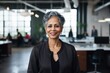 © NikoG - Smiling portrait of a senior Indian businesswoman in modern office
