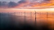 © ThomasStockArt - Aerial view of a massive offshore wind farm at sun
