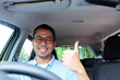 © KrishnaTedjo - A car driver smiling happy and give thumbs up