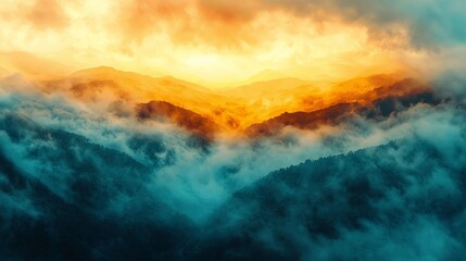 Wall Mural - A breathtaking view of misty mountains at sunrise, with vibrant orange and blue hues illuminating the sky and landscape.