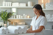 © Natali - young woman works in spa salon.  A masseuse or female massagist in a white robe is standing in a SPA salon near a massage chair. beautician in a cosmetology office. the cosmetologist is in the SPA