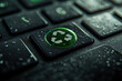© Mahmud - Closeup of a dark keyboard key with a green recycling symbol illuminated and water droplets on the surface