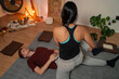 © phoenix021 - Masseuse performing Thai yoga massage on young adult man