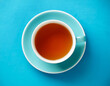 © Velocity - Teacup on soft blue surface Overhead perspective
