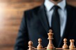 © Tonton54 - successful investor growth mindset concept. A businessman poised over a chessboard, symbolizing strategy and decision-making.