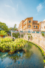 Wall Mural - Ortigia island, old cityspace town with turquoise sea of Syracuse. Small island on Sicily, Italy. Arethusa Spring