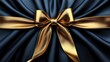 © Almahyra - Gold bow on dark blue silk fabric, elegant gift wrapping