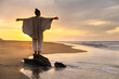 © Westend61 - Carefree woman wearing poncho and standing on rock under cloudy sky