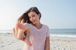 © Westend61 - Beautiful woman pointing at camera on beach