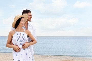 Wall Mural - Lovely couple spending time together on beach. Space for text