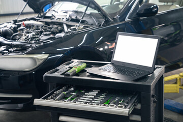 Wall Mural - Serviceman with laptop checks car software in car service