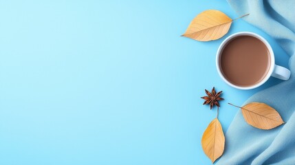 Wall Mural - A cup of coffee and some leaves on a blue background