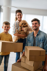 Poster - Smiling man and woman enjoy unpacking with child moving to own home. Rent, mortgage concept