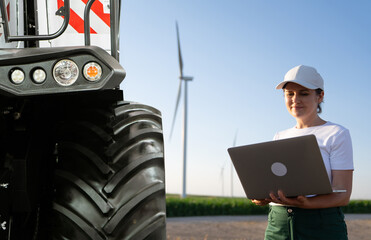 Aufkleber - Female farmer with laptop stands near combine harvester. Smart farming concept.