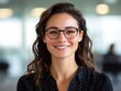 © Ankit - smiling businesswoman with glasses in office