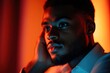 © Ankit - man with contemplative expression in colored lighting.