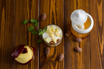 Wall Mural - sweet homemade yogurt in a glass with apples, nuts and honey