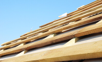 Sticker - Roofing construction. The roof is ready for roofing, wooden boards and a vapor barrier membrane close up.