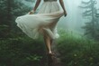 © ChaoticMind - Woman walks gracefully through misty forest trail wearing a flowing dress on a serene morning