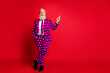 © deagreez - Full length body size view of his he nice attractive cheerful confident white-haired man wearing heart pattern costume pointing copy space isolated on bright vivid shine vibrant red color background