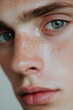 © Nikolai - A close-up photograph of a young man highlighting his natural skin texture. This image focuses on skincare and self-care, emphasizing healthy skin and personal grooming. The minimalistic style creates