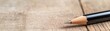 © Jiraphat - Close-up of a sharpened pencil resting on a wooden surface.