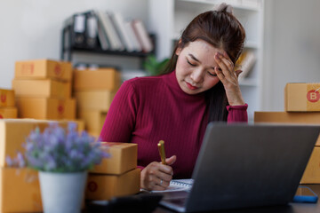 Small Business, Startup SME, Owner Entrepreneurs. Asian woman with unsuccess business online shopping crying and serious face unhappy mood,SME telemarket bankrupt stress concept.