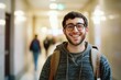 © vefimov - Student with glasses walking down corridor at school, smiling brightly.