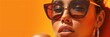 © Leifur - Close-up of a confident woman wearing oversized sunglasses with an orange background, highlighting a bold and modern fashion statement.