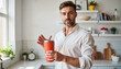© Margarita - Smiling man holding a reusable coffee cup in a modern kitchen for blogs, websites, eco-friendly presentations, social media, and lifestyle content creation.