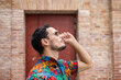 © ADDICTIVE STOCK - Cuban man in colorful shirt with confident pose outdoors