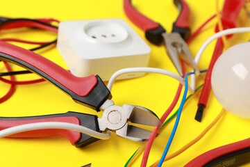 Wall Mural - Different electrical tools on yellow background, closeup