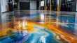 © Formasi - Polished concrete floor with metallic pigments, swirling blue, orange, and yellow patterns reflecting light in a large industrial space.