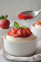 Wall Mural -  drizzling strawberry sauce on pudding